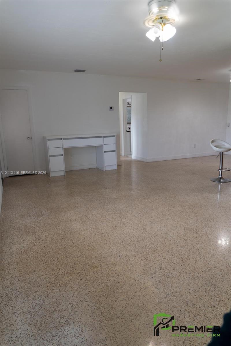 Polished terrazzo flooring, built-in white cabinetry, and multi-globe ceiling-mounted lighting