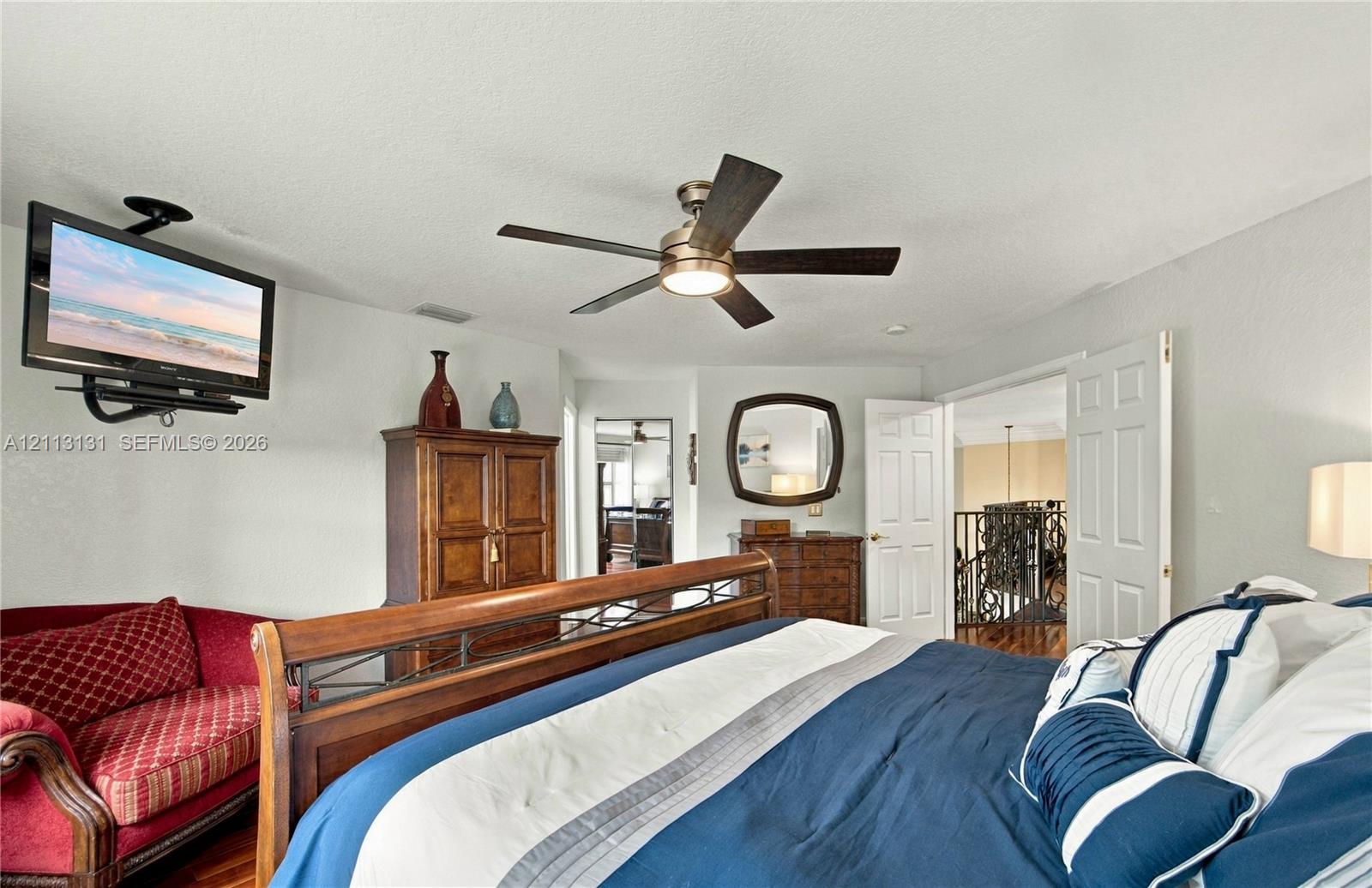 Neutral wall color palette, multi-blade ceiling fan with integrated lighting, and white six-panel interior doors