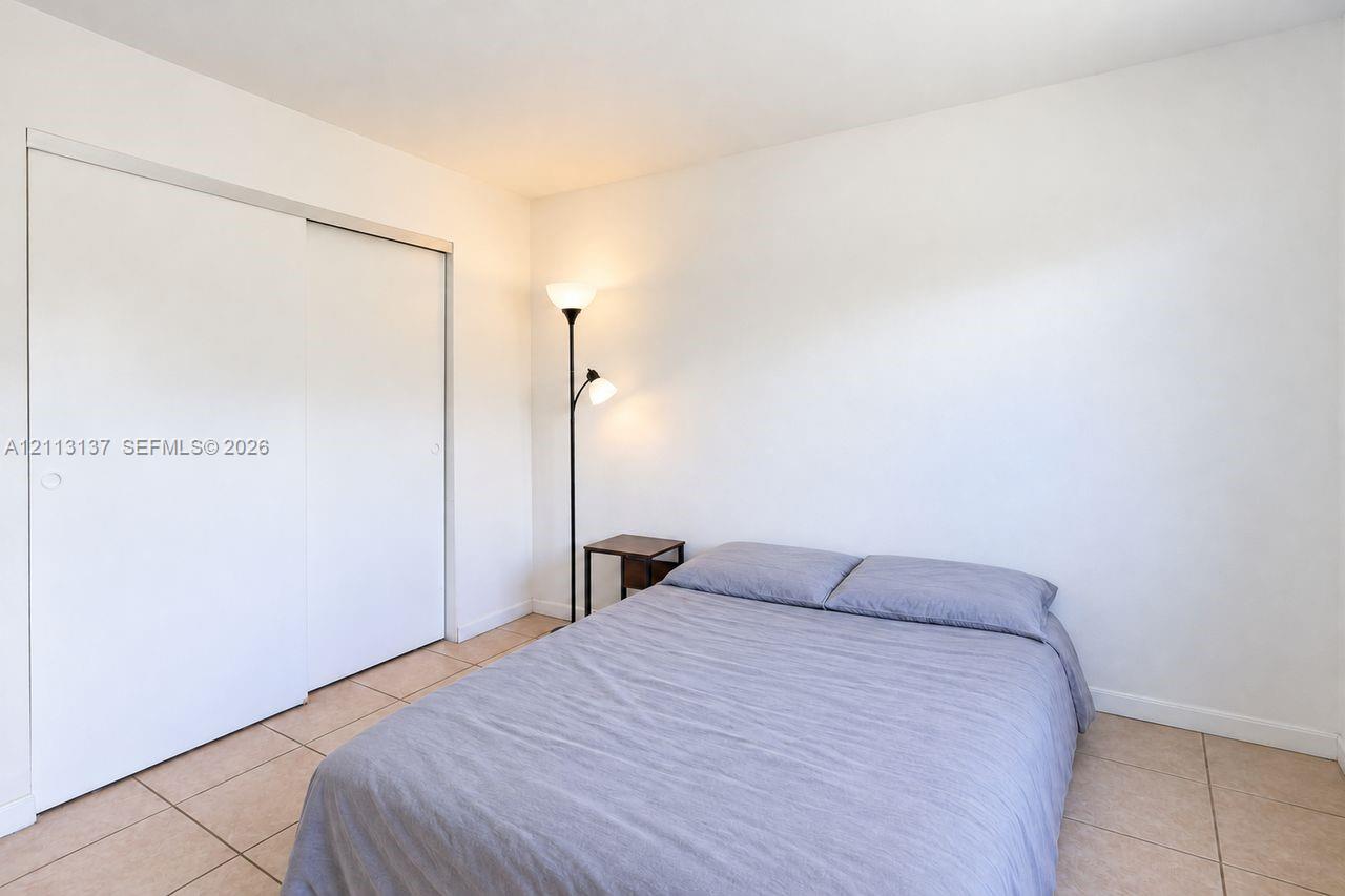 Ceramic tile flooring and a double-panel sliding closet