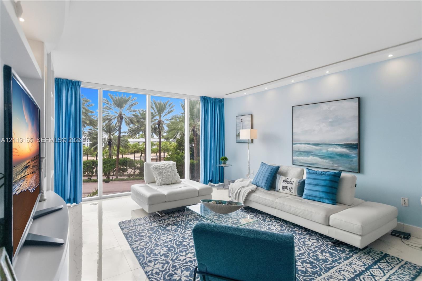 Floor-to-ceiling windows, polished stone flooring, and recessed ceiling lighting