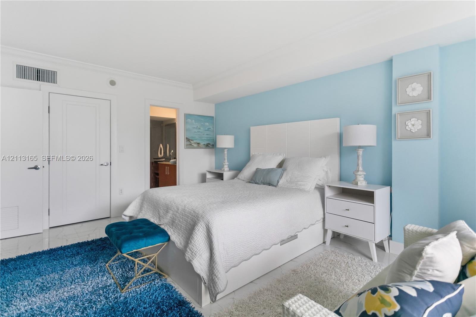 Room featuring polished tile flooring, smooth ceilings, and solid-core doors