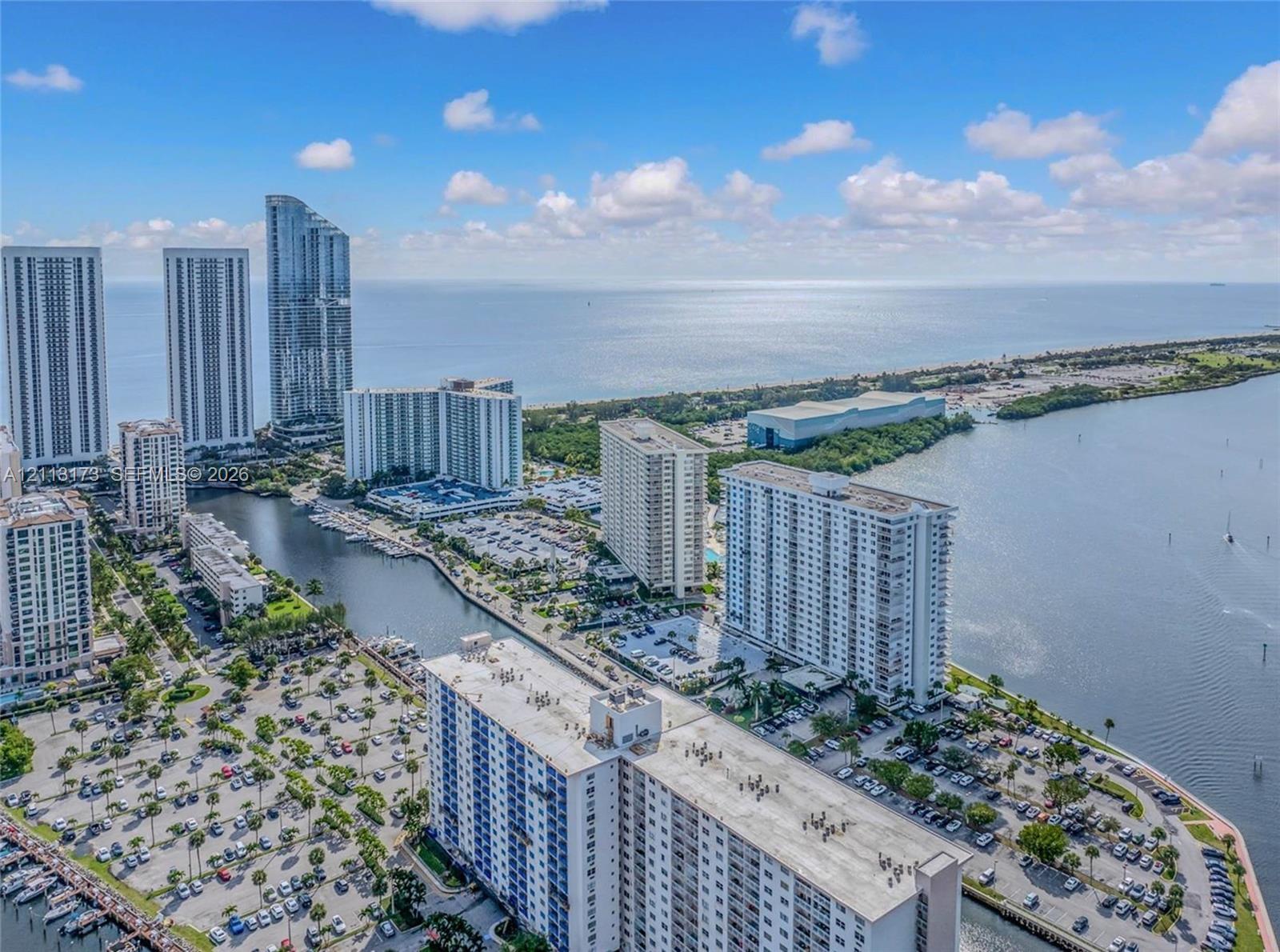 Aerial perspective of coastal high-rise development featuring waterfront proximity, deep-water canal access, paved surface parking, and proximity to the Atlantic Ocean Aerial perspective of coastal high-rise development featuring waterfront proximity, deep-water canal access, paved surface parking, and proximity to the Atlantic Ocean