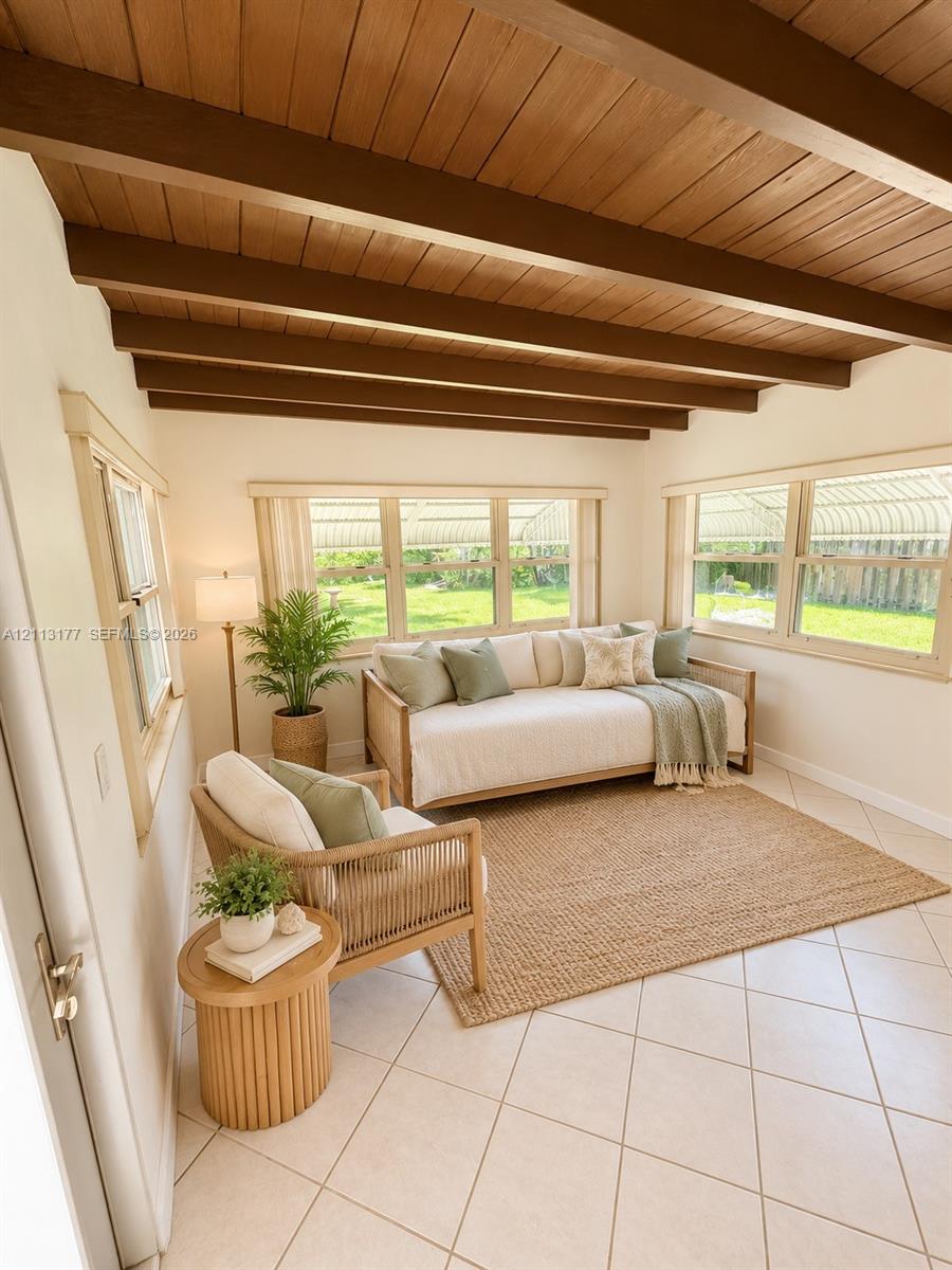 Exposed wood ceiling beams, wood-plank ceiling, large multi-pane windows, and ceramic tile flooring