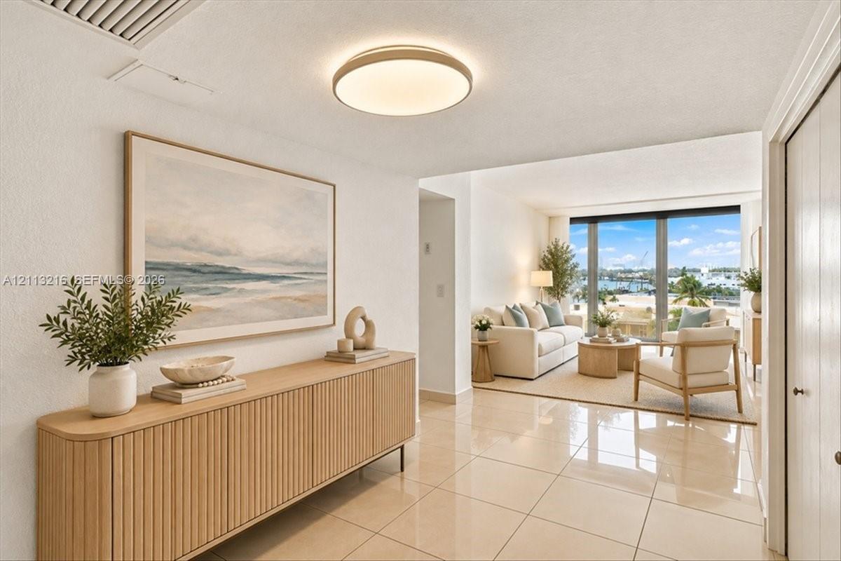 Polished stone tile flooring, neutral wall tones, low-profile circular LED flush-mount lighting, and floor-to-ceiling glass panel windows Polished stone tile flooring, neutral wall tones, low-profile circular LED flush-mount lighting, and floor-to-ceiling glass panel windows