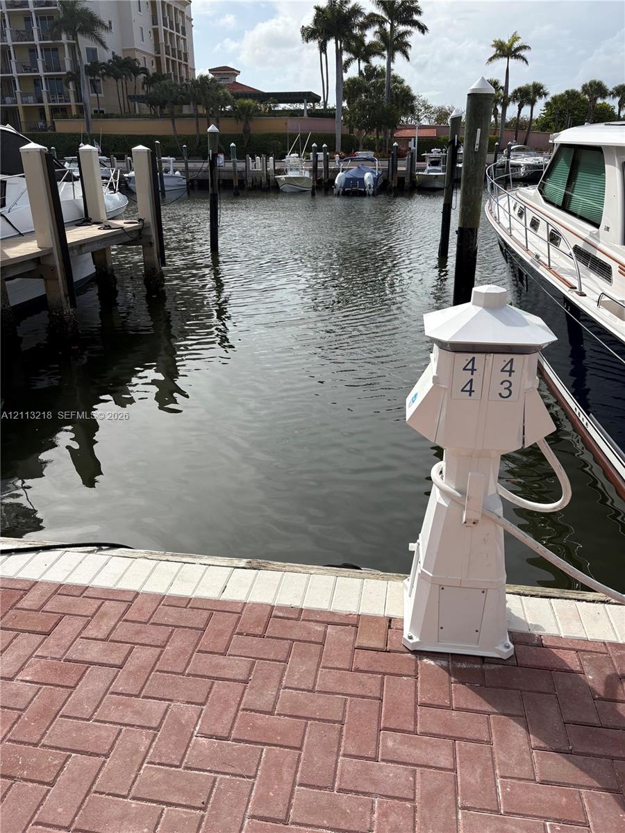 Private boat slip with brick-paver docking area, mooring pilings, and dedicated shore power pedestal Private boat slip with brick-paver docking area, mooring pilings, and dedicated shore power pedestal