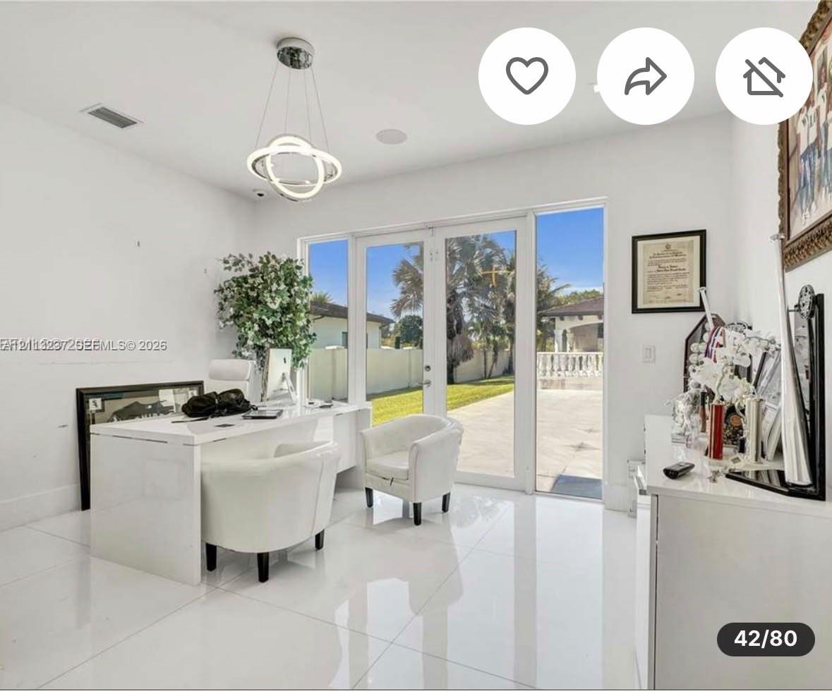 High-gloss tiled flooring, modern circular pendant lighting, and full-length glass paneled double doors with sidelights
