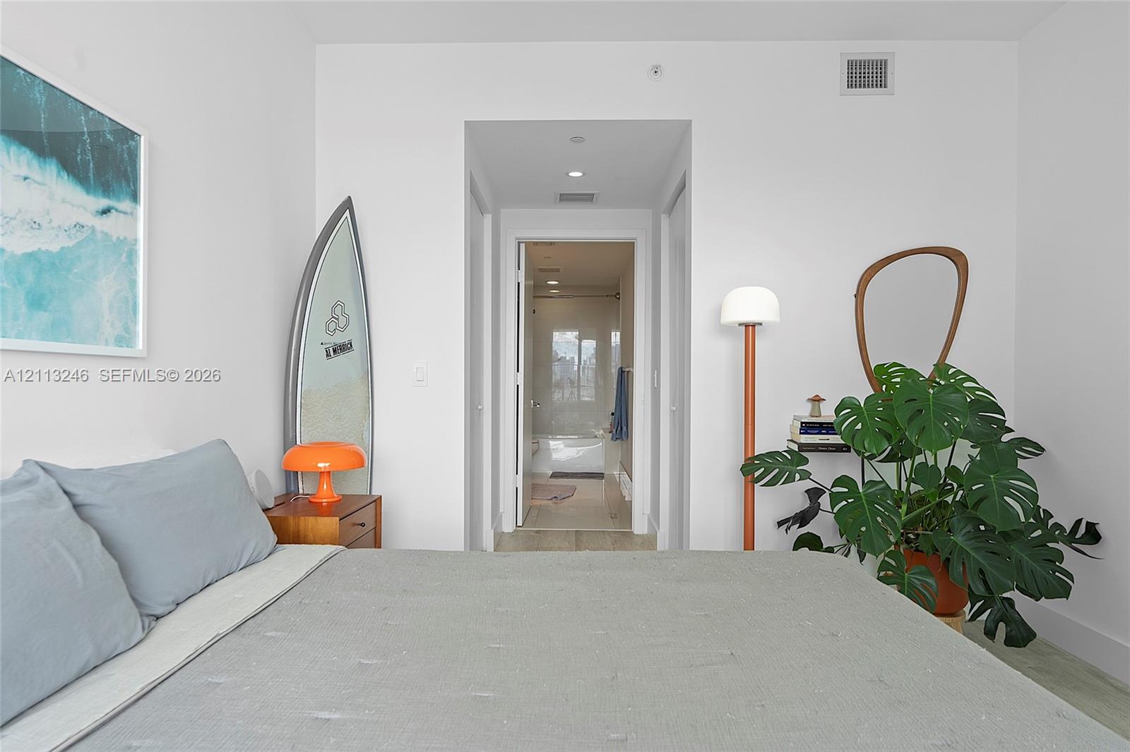 Neutral interior space featuring recessed ceiling lighting, crisp white wall finishes, and light-toned flooring