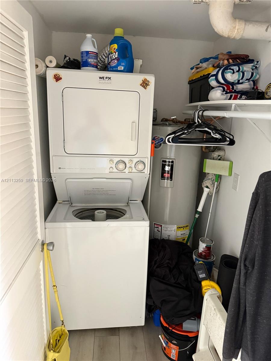 Laundry closet equipped with a stacked laundry unit and a dedicated water heater