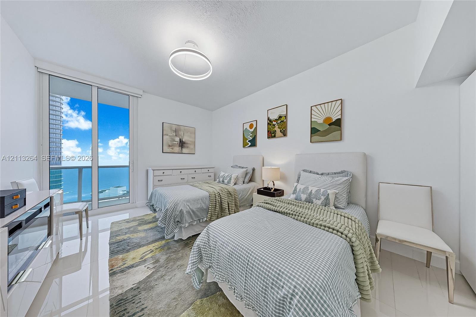 Floor-to-ceiling sliding glass doors, reflective large-format tile flooring, circular LED flush-mount lighting, and exterior glass-paneled balcony