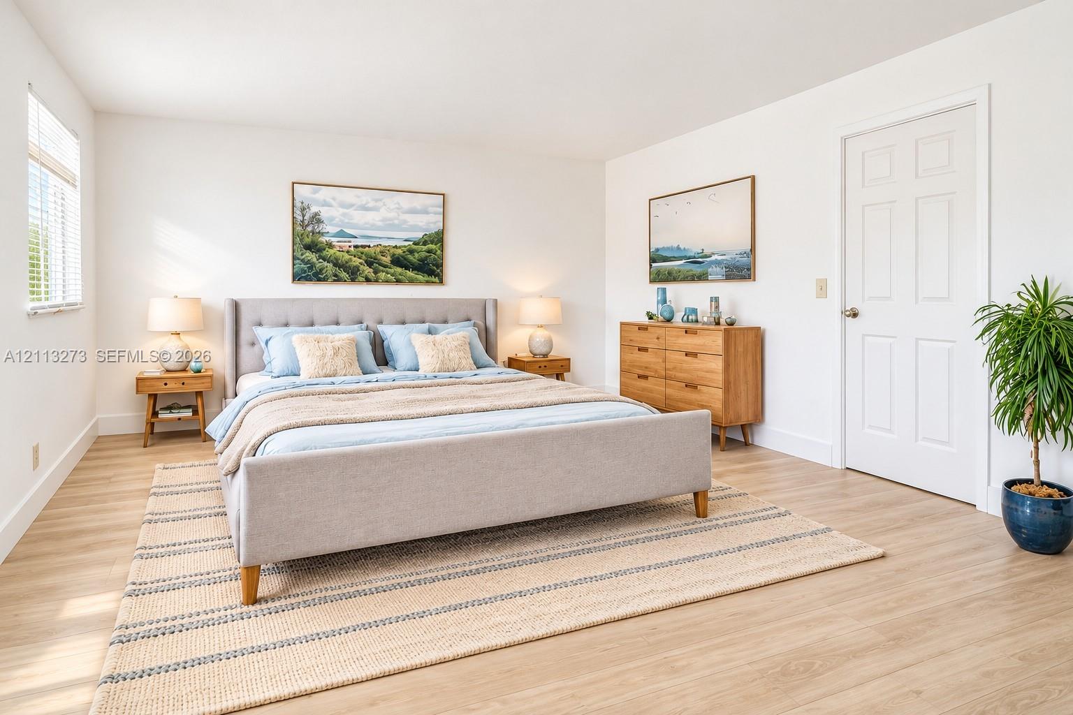Wood-finish flooring, white walls, and a white six-panel interior door Wood-finish flooring, white walls, and a white six-panel interior door