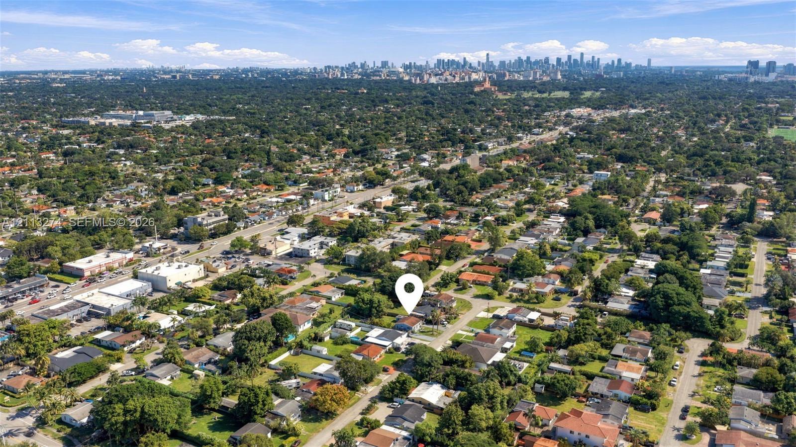 Aerial perspective of the property location featuring mature tree canopy, established neighborhood grid, and distant urban skyline Aerial perspective of the property location featuring mature tree canopy, established neighborhood grid, and distant urban skyline