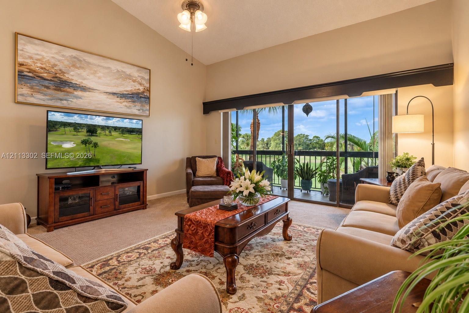 Vaulted ceilings, sliding glass doors, and a screened-in balcony featuring exterior railings