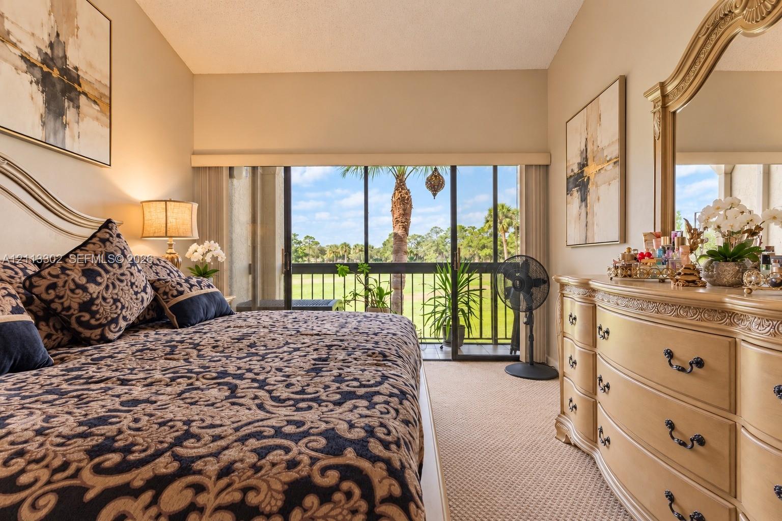 Full-height sliding glass doors with black framing, wall-to-wall carpeting, and neutral paint palette