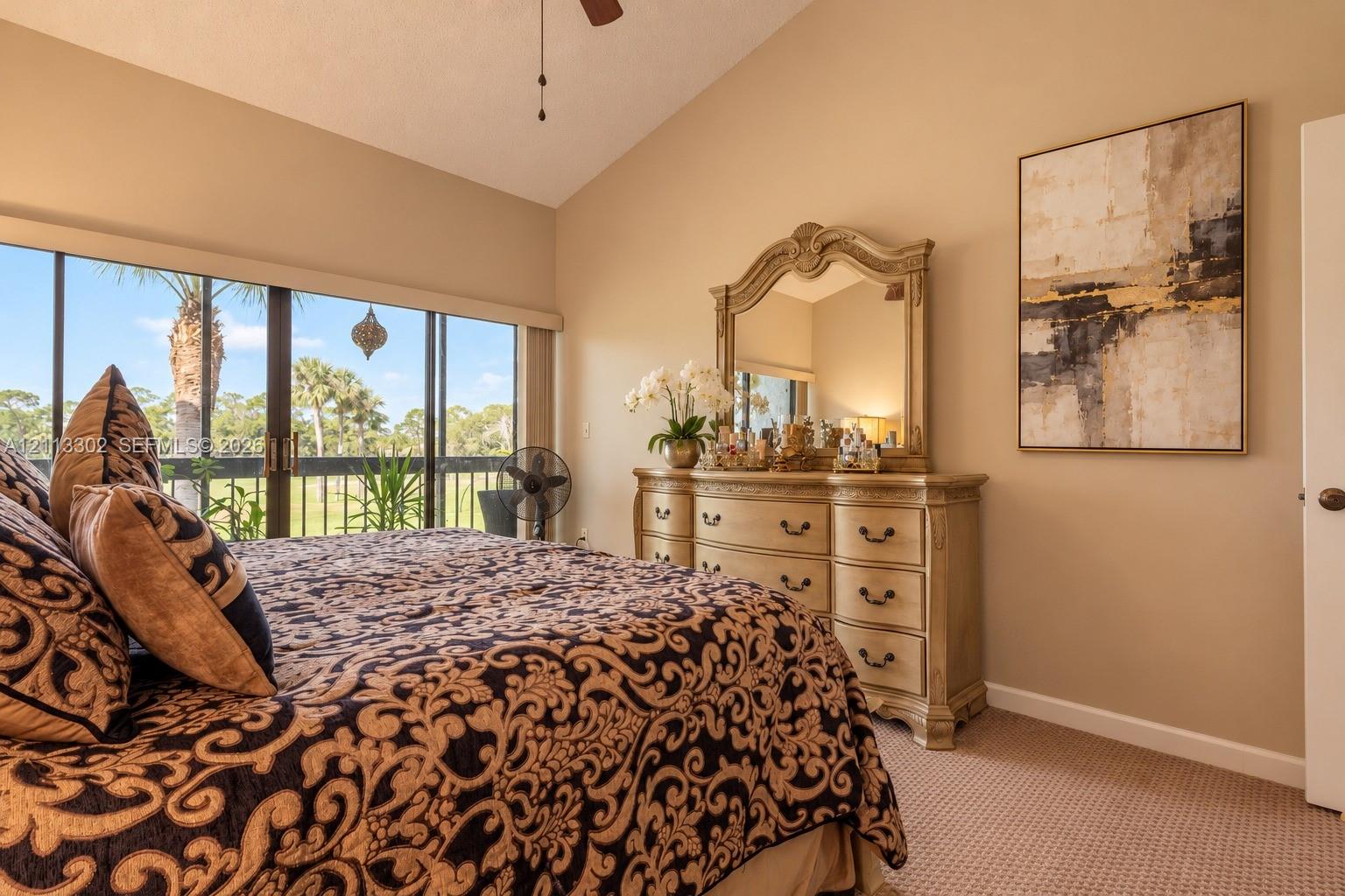Vaulted ceiling, wall-to-wall carpeting, and sliding glass doors with exterior screen enclosure