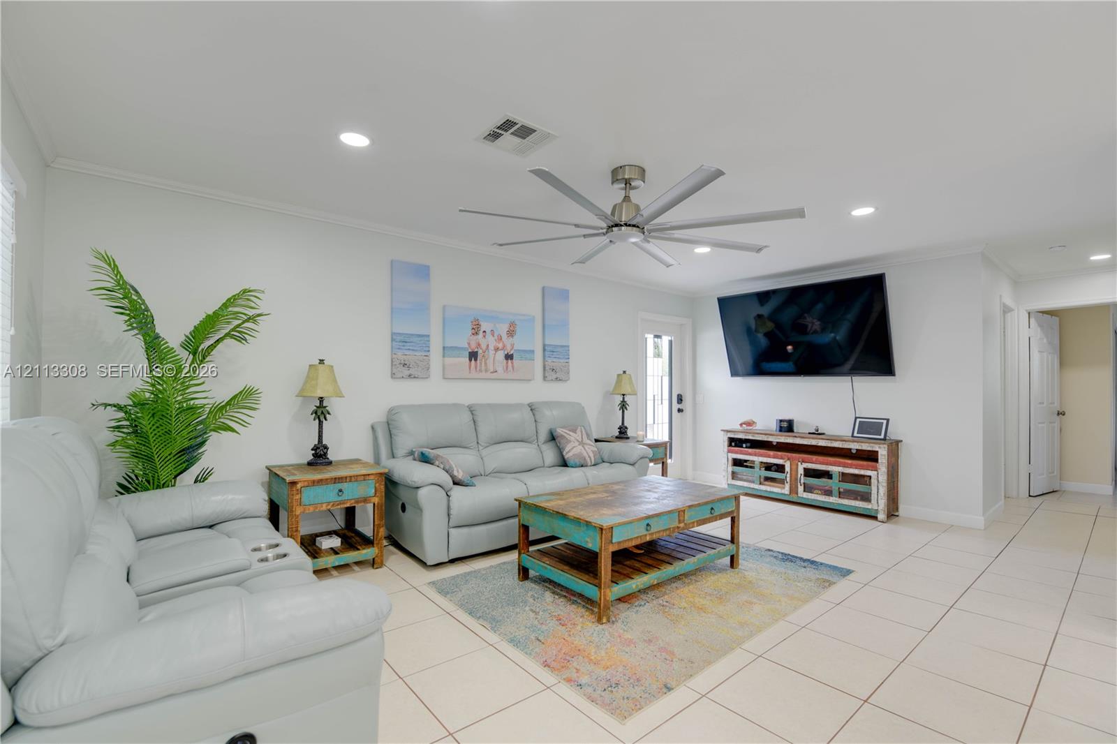 Large living area featuring neutral tile flooring, recessed lighting, and a multi-blade ceiling fan Large living area featuring neutral tile flooring, recessed lighting, and a multi-blade ceiling fan