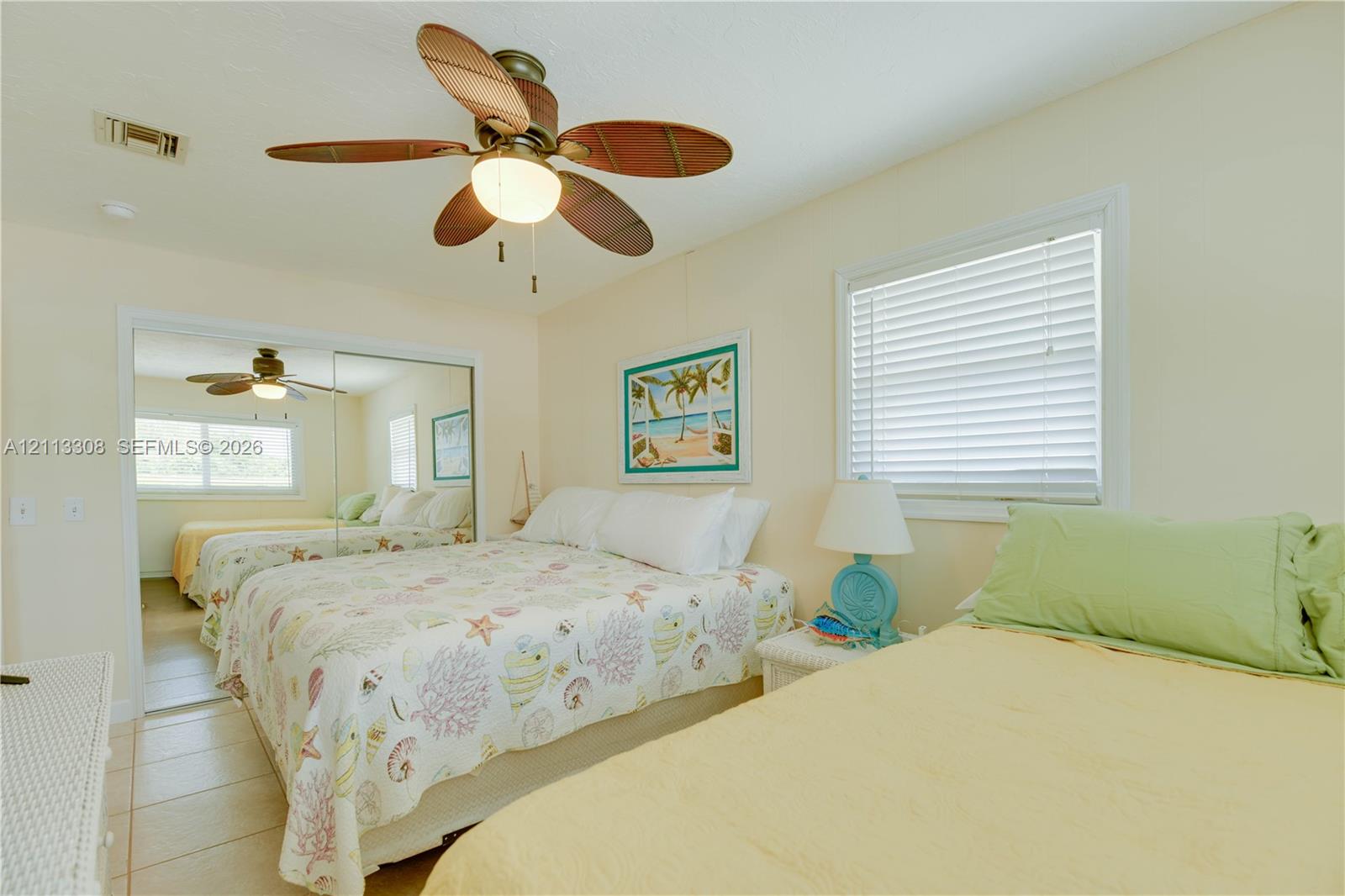 Ceiling fan with integrated lighting, tile flooring, and sliding mirror closet doors Ceiling fan with integrated lighting, tile flooring, and sliding mirror closet doors