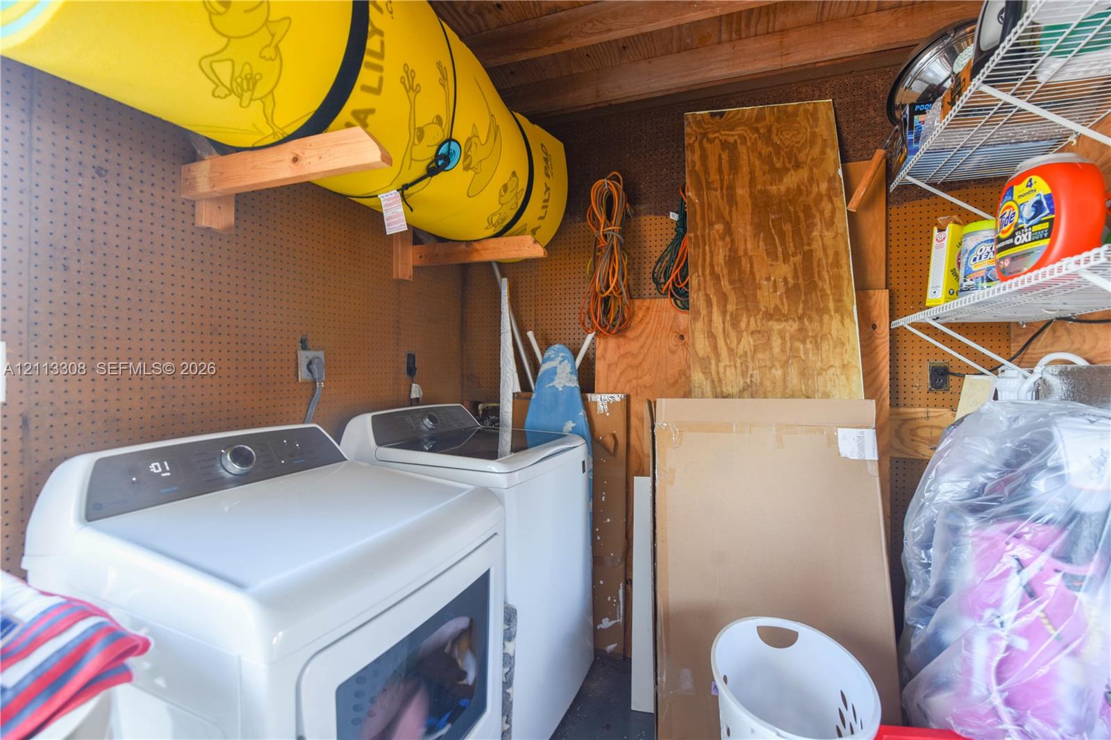 Pegboard wall storage, custom wooden wall-mounted rack, and white wire shelving
