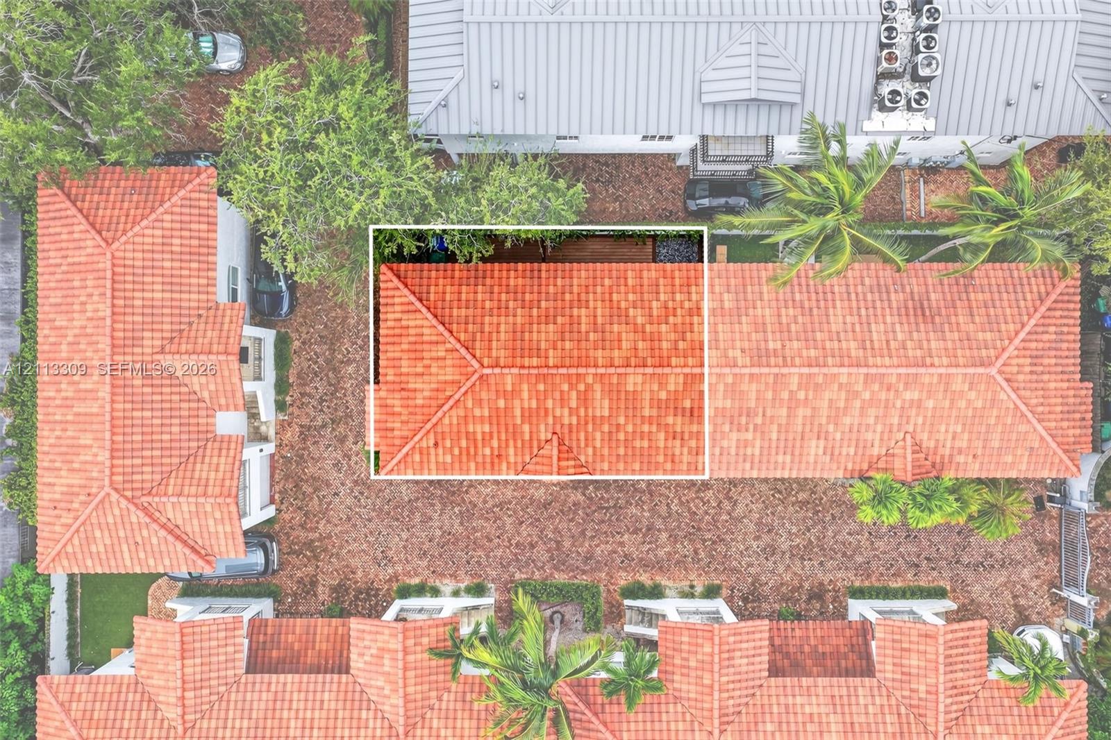 Aerial perspective featuring terracotta-style roof tiles and mature landscaping