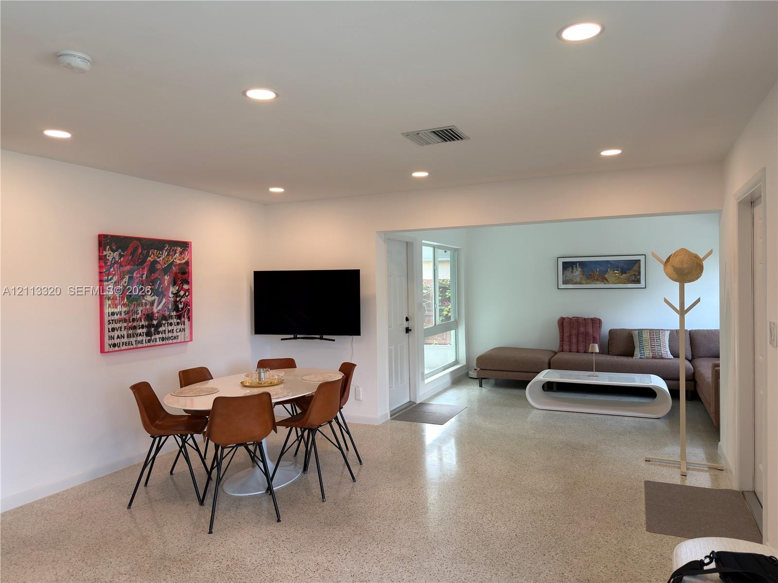 Open floor plan featuring polished stone-aggregate flooring and recessed LED lighting throughout