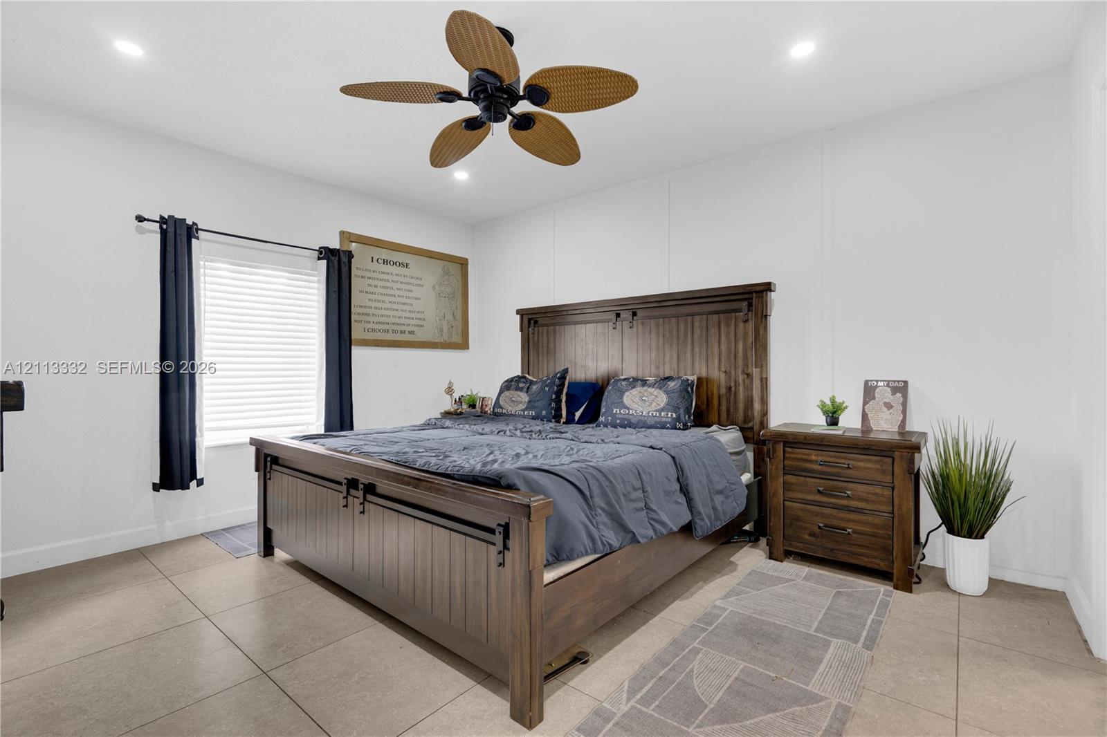 Neutral-toned tile flooring, recessed ceiling lighting, and a multi-blade ceiling fan with wood-finish accents