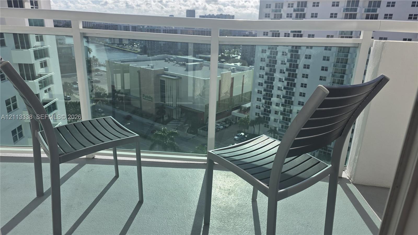 Private balcony featuring a glass panel railing and a concrete surface