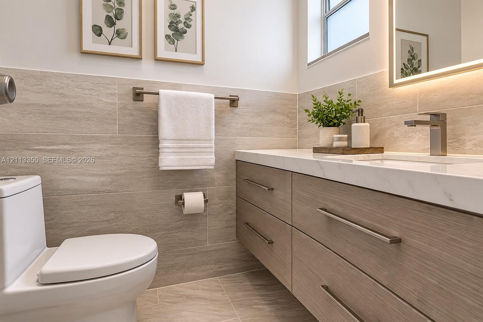 AI RENDERING-Floating wood-finish vanity with a white integrated countertop, wall-to-wall light-toned horizontal tile wainscoting, and an LED-backlit mirror