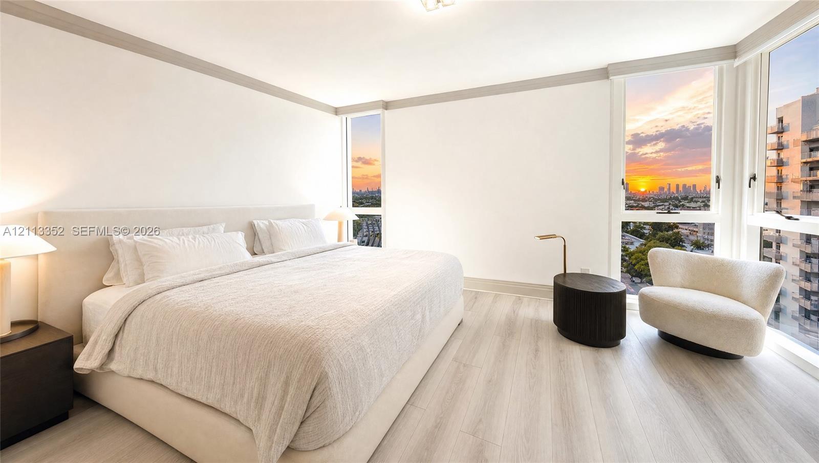 Floor-to-ceiling windows, wood-finish flooring, and recessed ceiling lighting