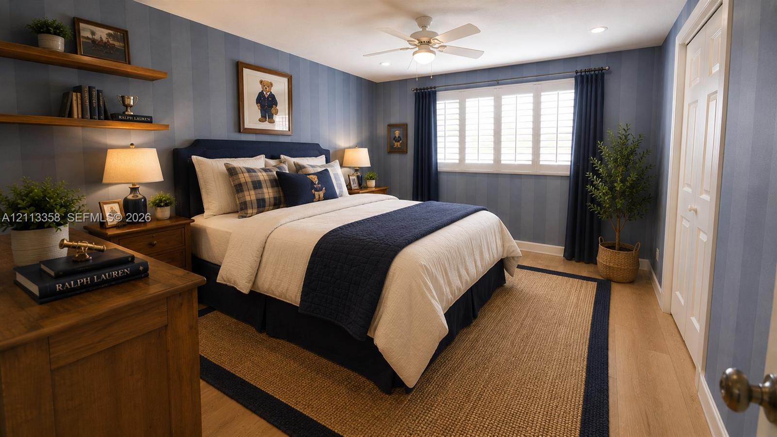Striped wallcovering, wood-finish flooring, plantation shutters, ceiling fan, and built-in wall shelving