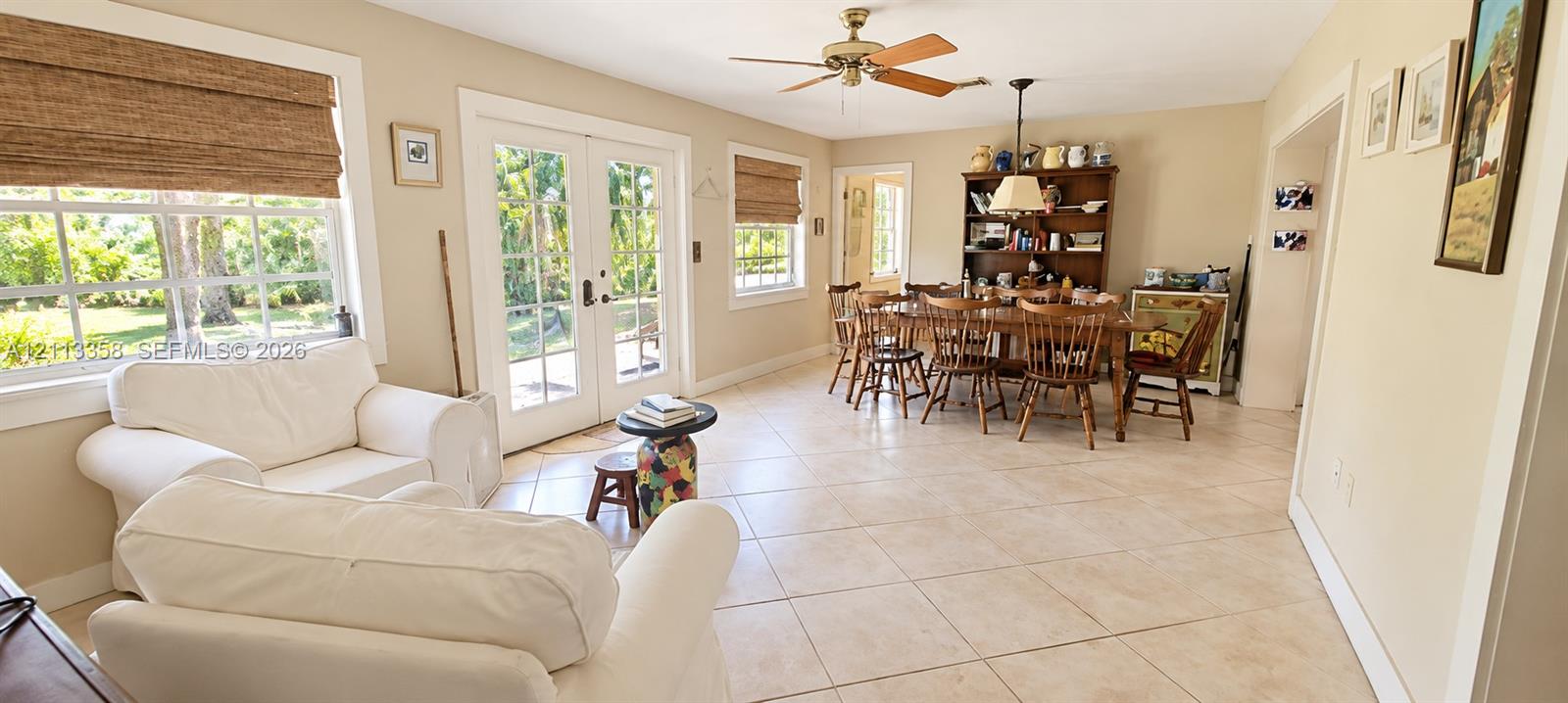 Ceramic tile flooring, French doors, ceiling fan, and multi-pane windows