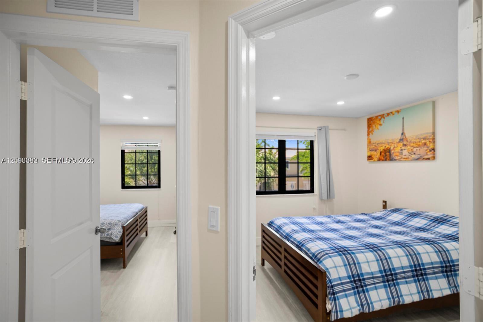 Interior spaces featuring neutral wall paint, recessed lighting, wood-finish flooring, and multi-pane windows with black frames