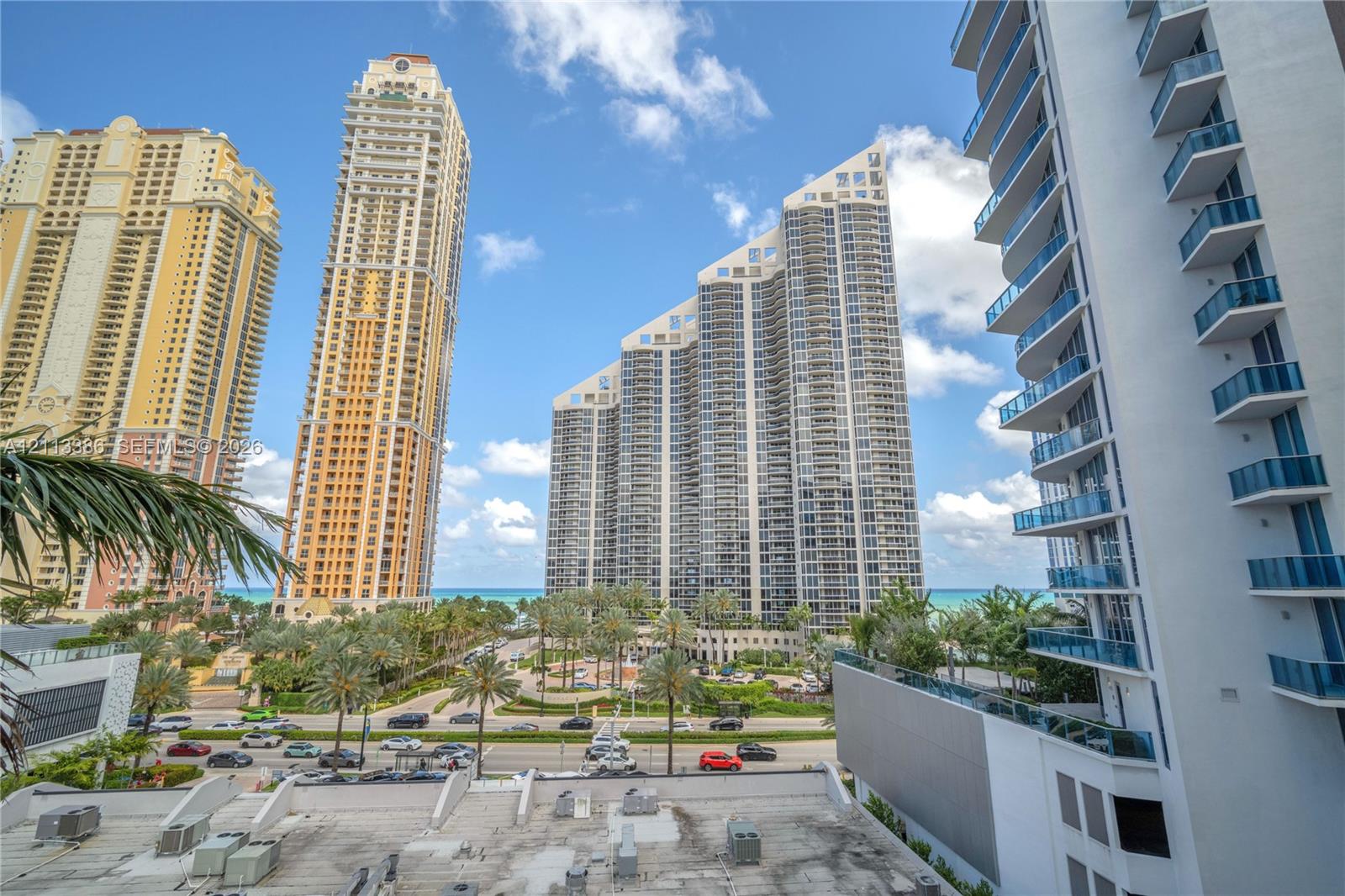 High-rise exterior featuring stacked glass-railing balconies and architectural building facades set against a coastal backdrop High-rise exterior featuring stacked glass-railing balconies and architectural building facades set against a coastal backdrop