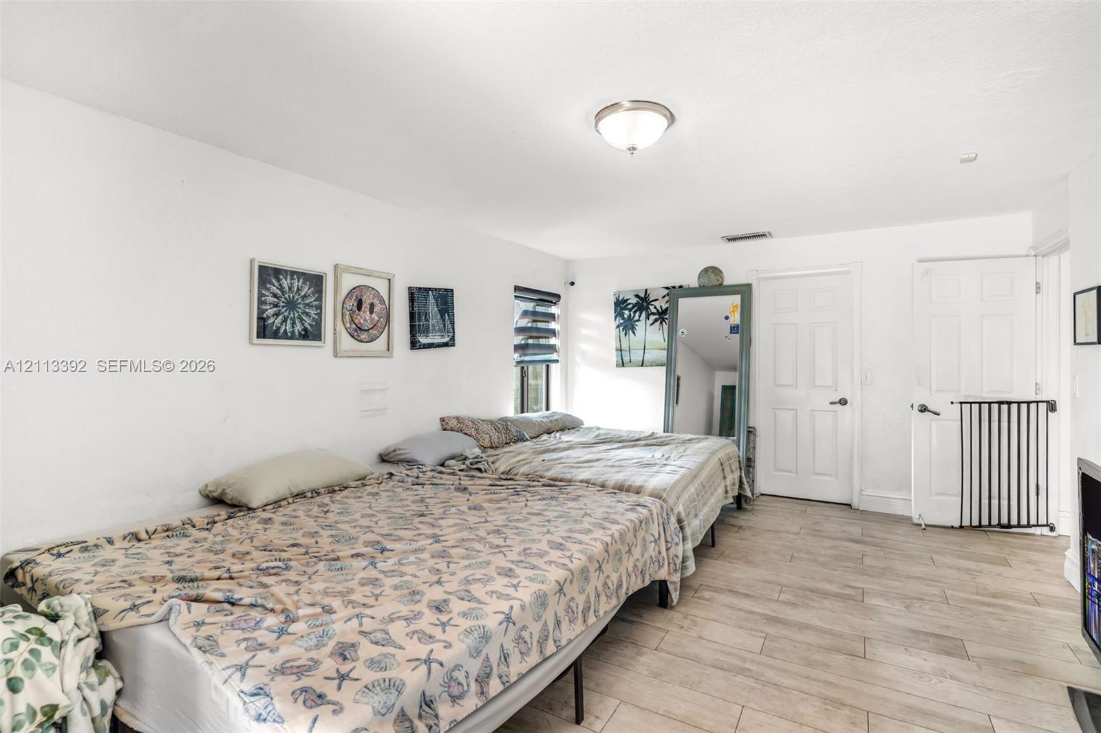 Neutral-toned tile flooring, flush-mount ceiling lighting, and solid-core interior doors