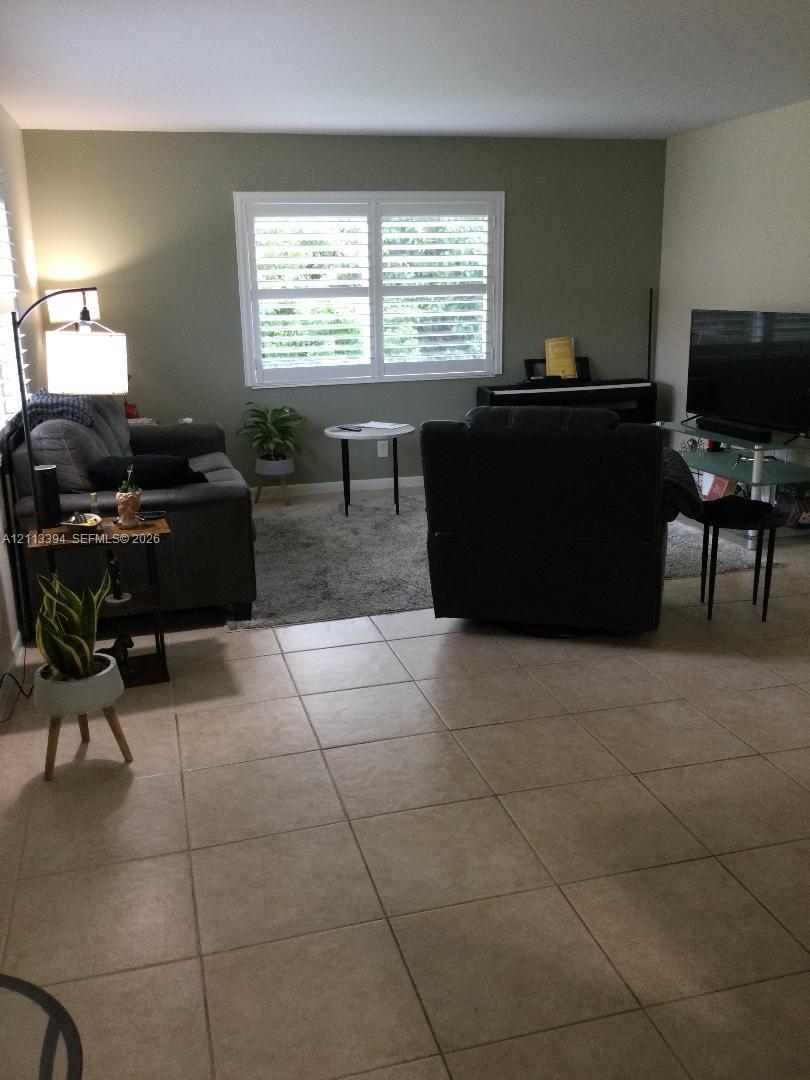 Neutral-toned tile flooring and window shutters