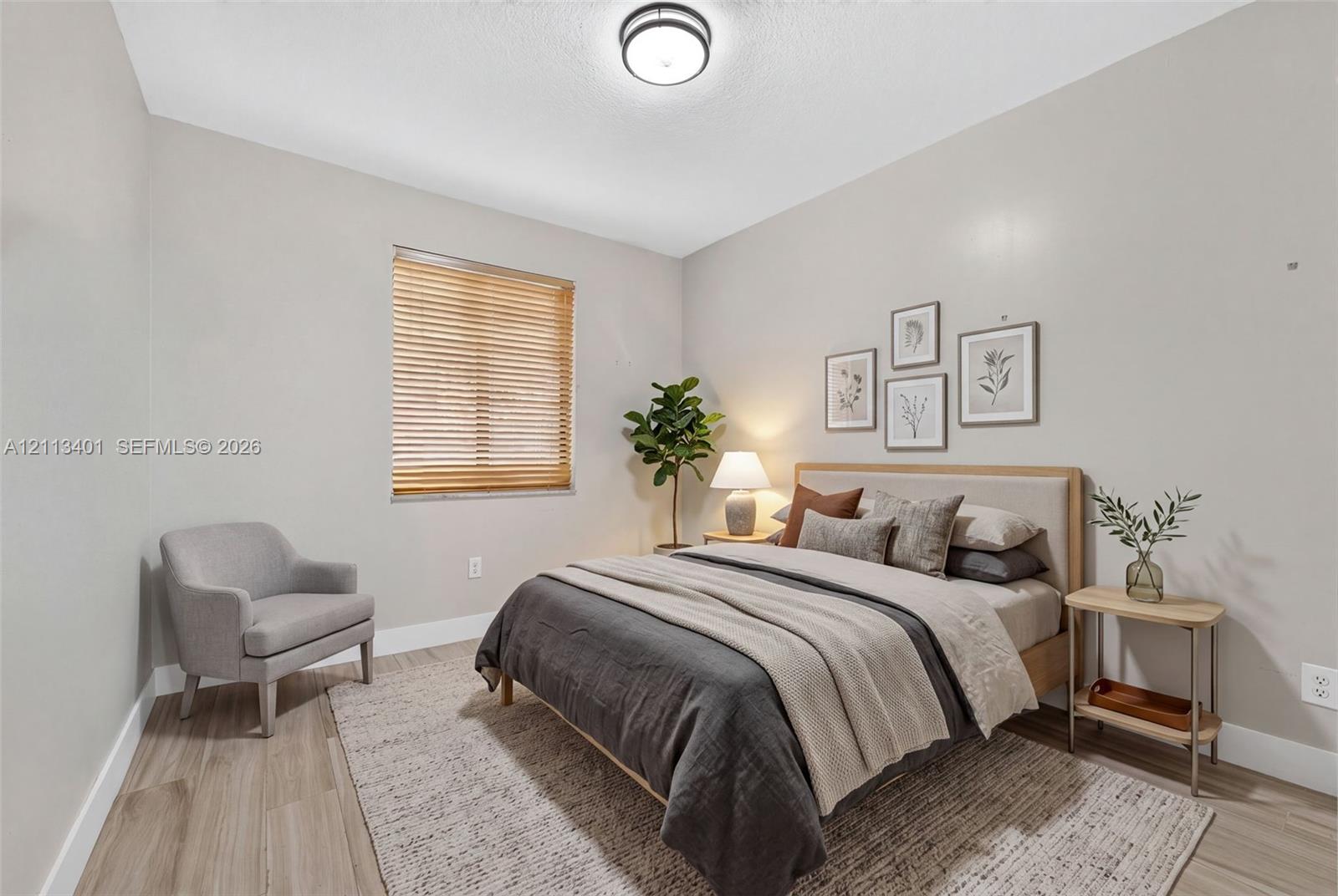 Wood-finish flooring, neutral wall tones, and recessed overhead lighting