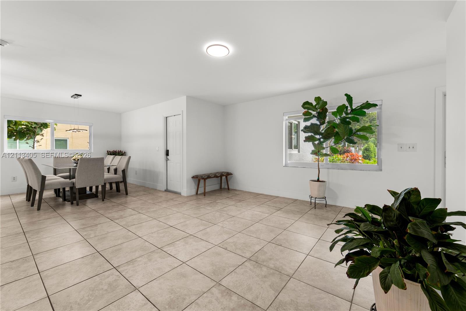 Neutral-toned tile flooring, recessed ceiling lighting, and horizontal sliding windows