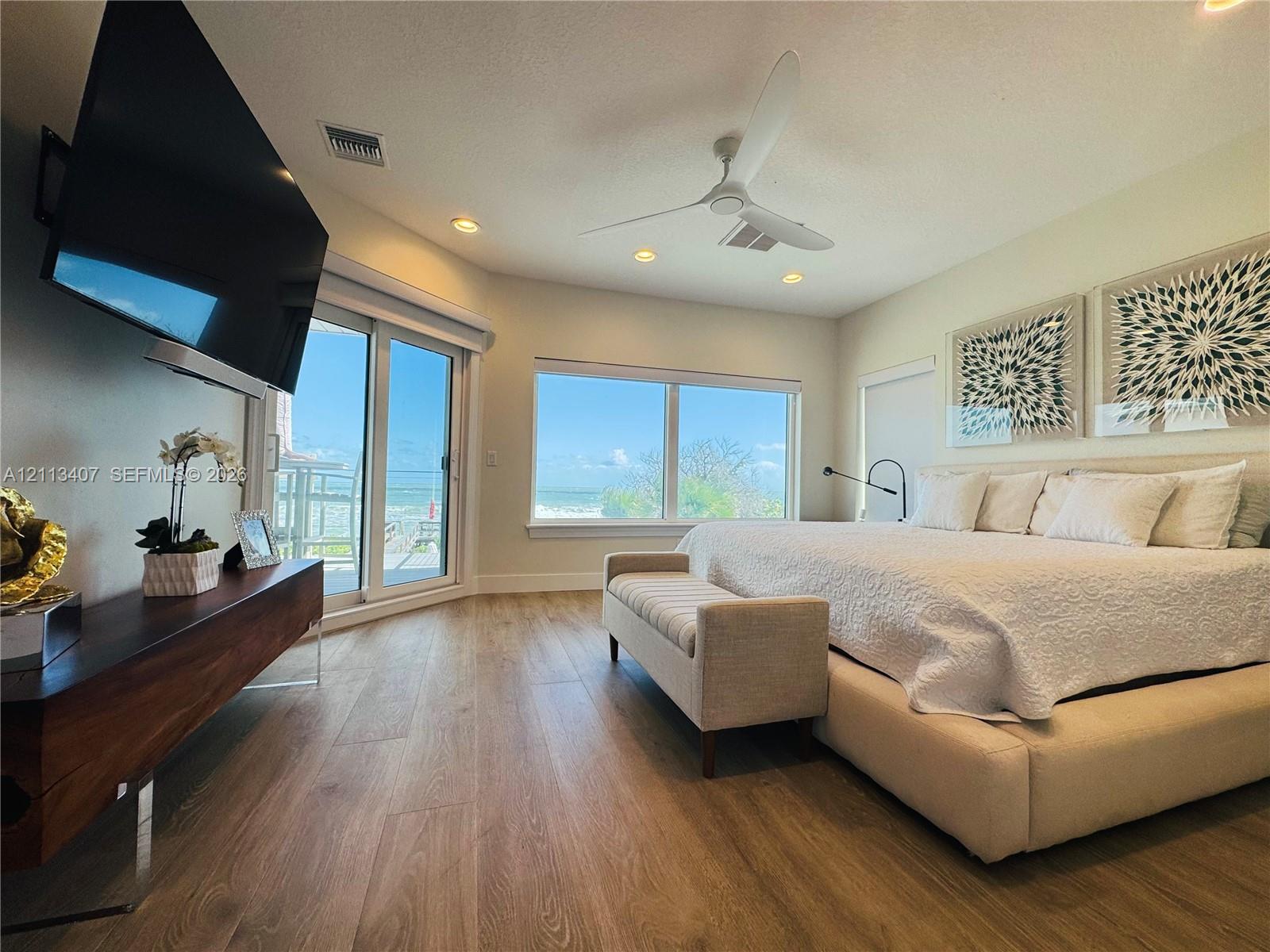 Second floor Wood-finish flooring, recessed lighting, modern ceiling fan, floor-to-ceiling windows, and sliding glass door