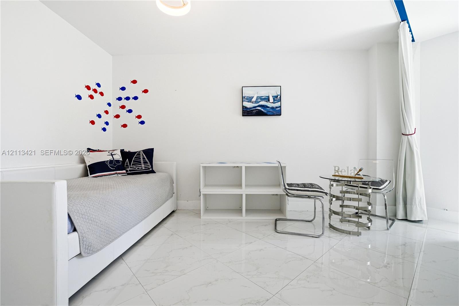 Polished stone-finish tile flooring, white walls, and built-in shelving unit