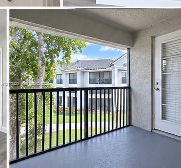 Covered balcony featuring a textured stucco ceiling, durable grey flooring, and a black metal railing