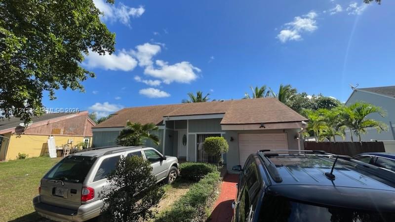Single-story residence featuring a shingle roof, lap siding exterior, attached one-car garage, and a brick-paved walkway Single-story residence featuring a shingle roof, lap siding exterior, attached one-car garage, and a brick-paved walkway