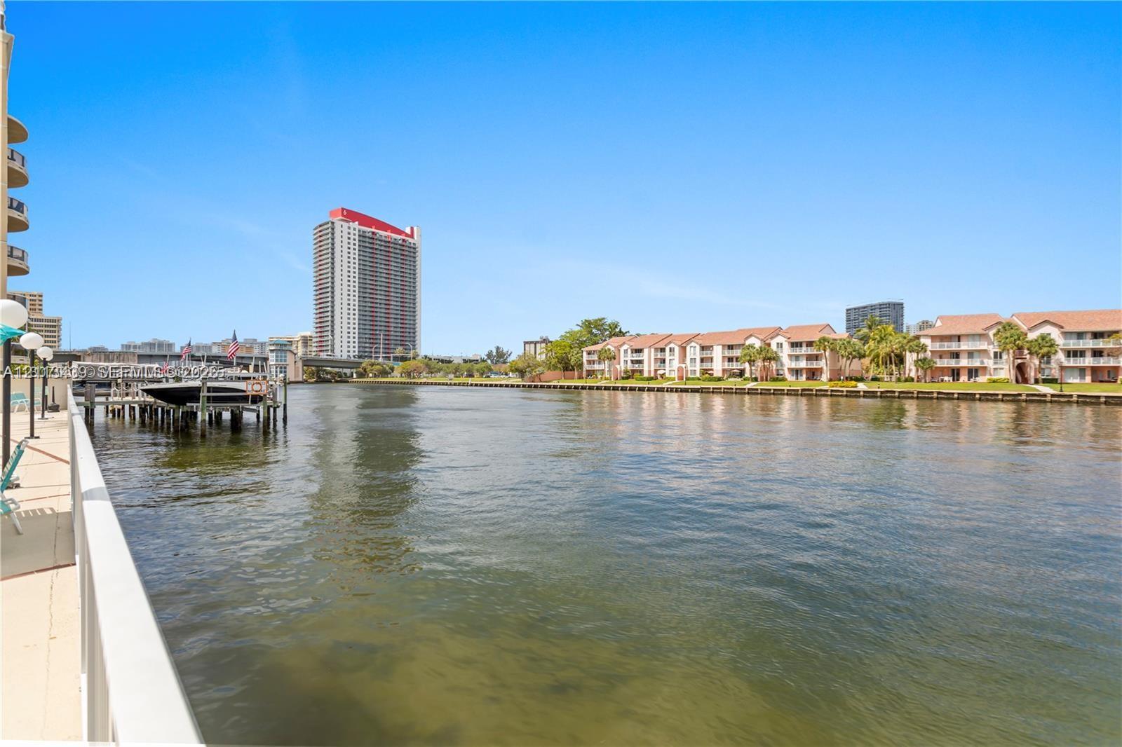 Waterfront walkway featuring a concrete bulkhead and private boat dock