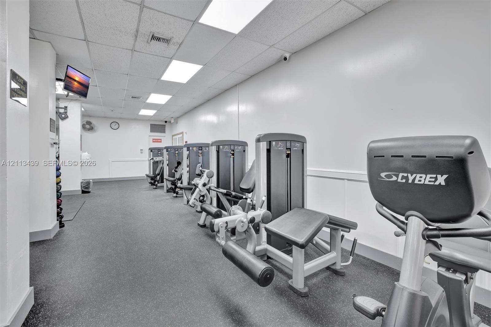 Fitness center featuring durable rubberized flooring, recessed ceiling lighting, and built-in weight training equipment