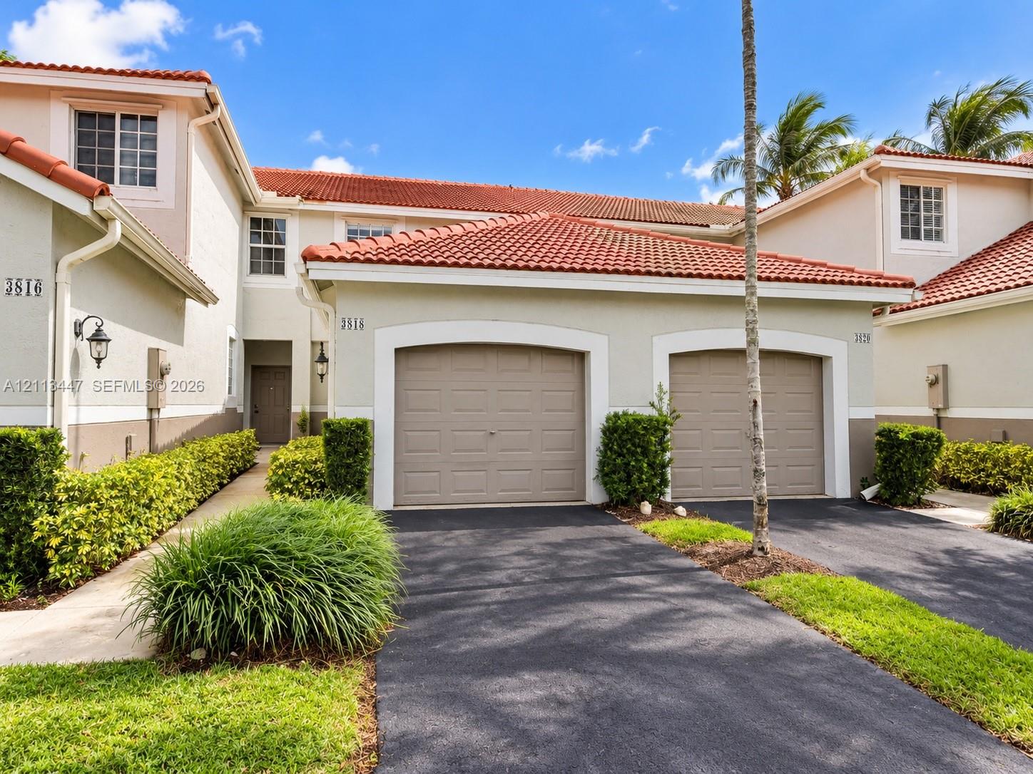 Stucco exterior with a tiled roof, one-car garage, and paved driveway