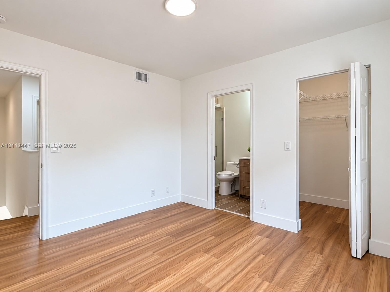 Luxury laminated flooring, recessed ceiling lighting, and multi-panel interior doors