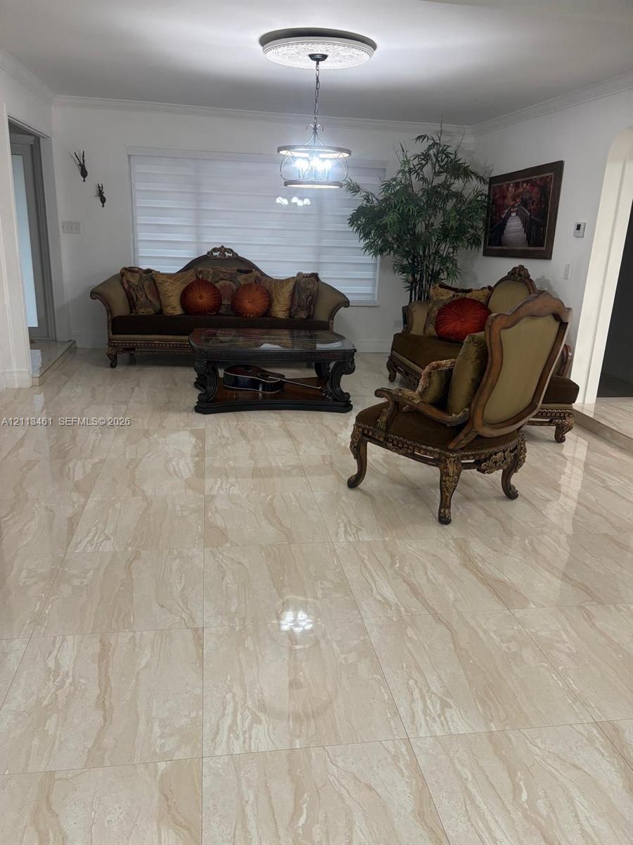 Polished stone-finish tile flooring, decorative ceiling medallion, and custom pendant lighting fixture