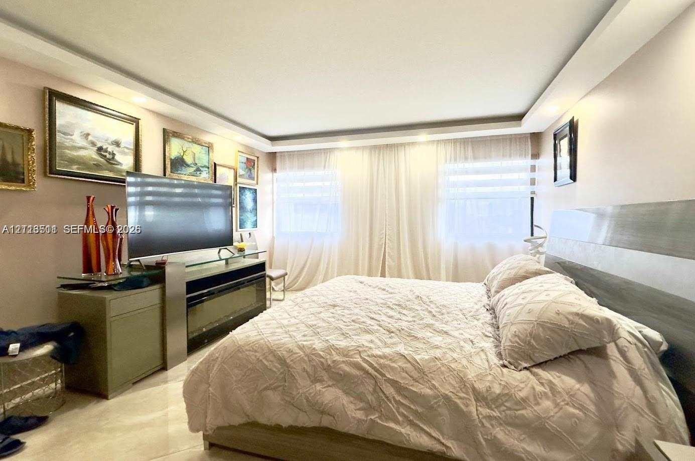 Tray ceiling with recessed lighting and large-format tile flooring