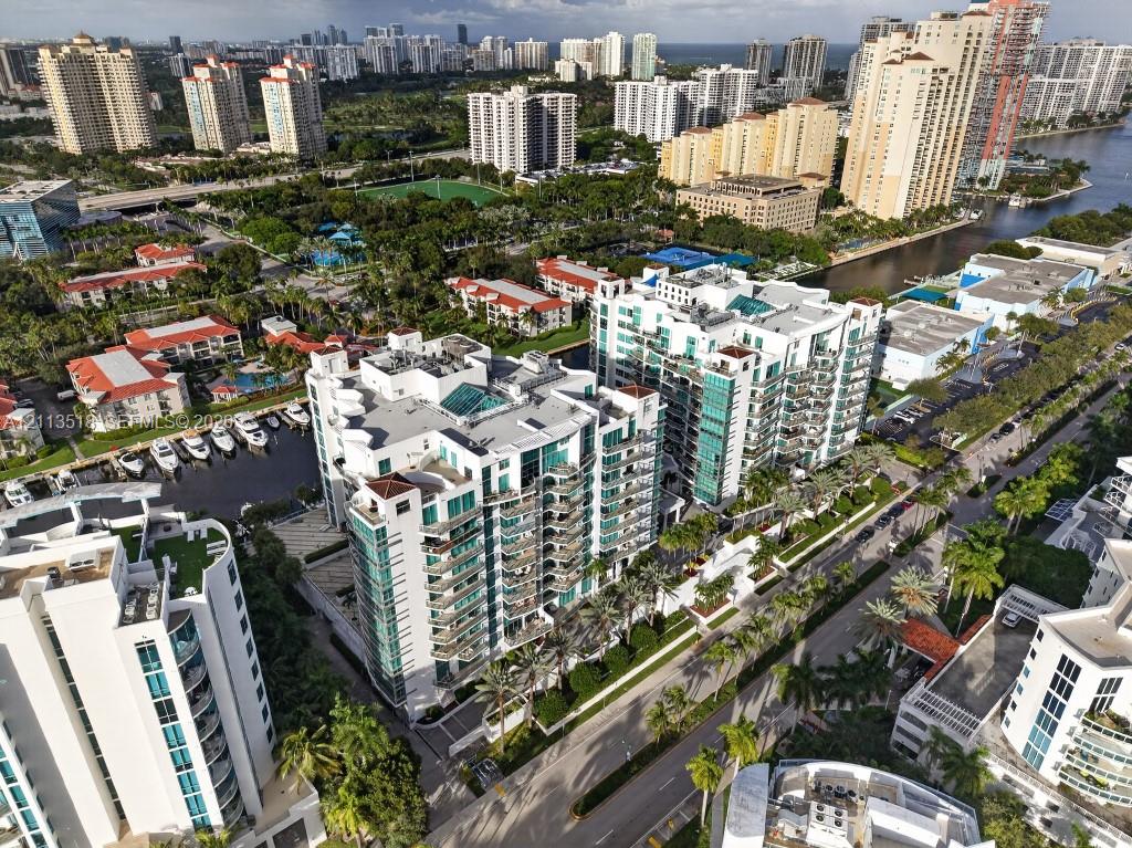 High-rise residential complex featuring glass-paneled balconies, multi-story structural design, dedicated marina slips, and extensive perimeter landscaping
