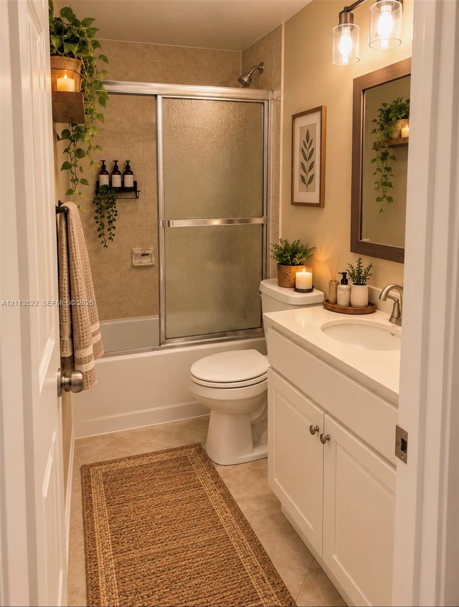 White vanity cabinet featuring a solid surface countertop with an integrated oval sink, chrome finish faucet, framed wall-mounted mirror, brushed-finish double-light fixture, and a sliding glass door shower enclosure White vanity cabinet featuring a solid surface countertop with an integrated oval sink, chrome finish faucet, framed wall-mounted mirror, brushed-finish double-light fixture, and a sliding glass door shower enclosure