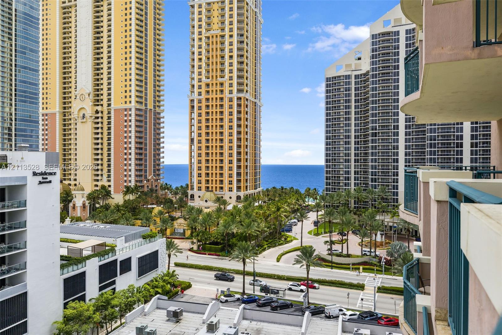 High-rise balcony featuring metal railings with ocean and skyline exposure