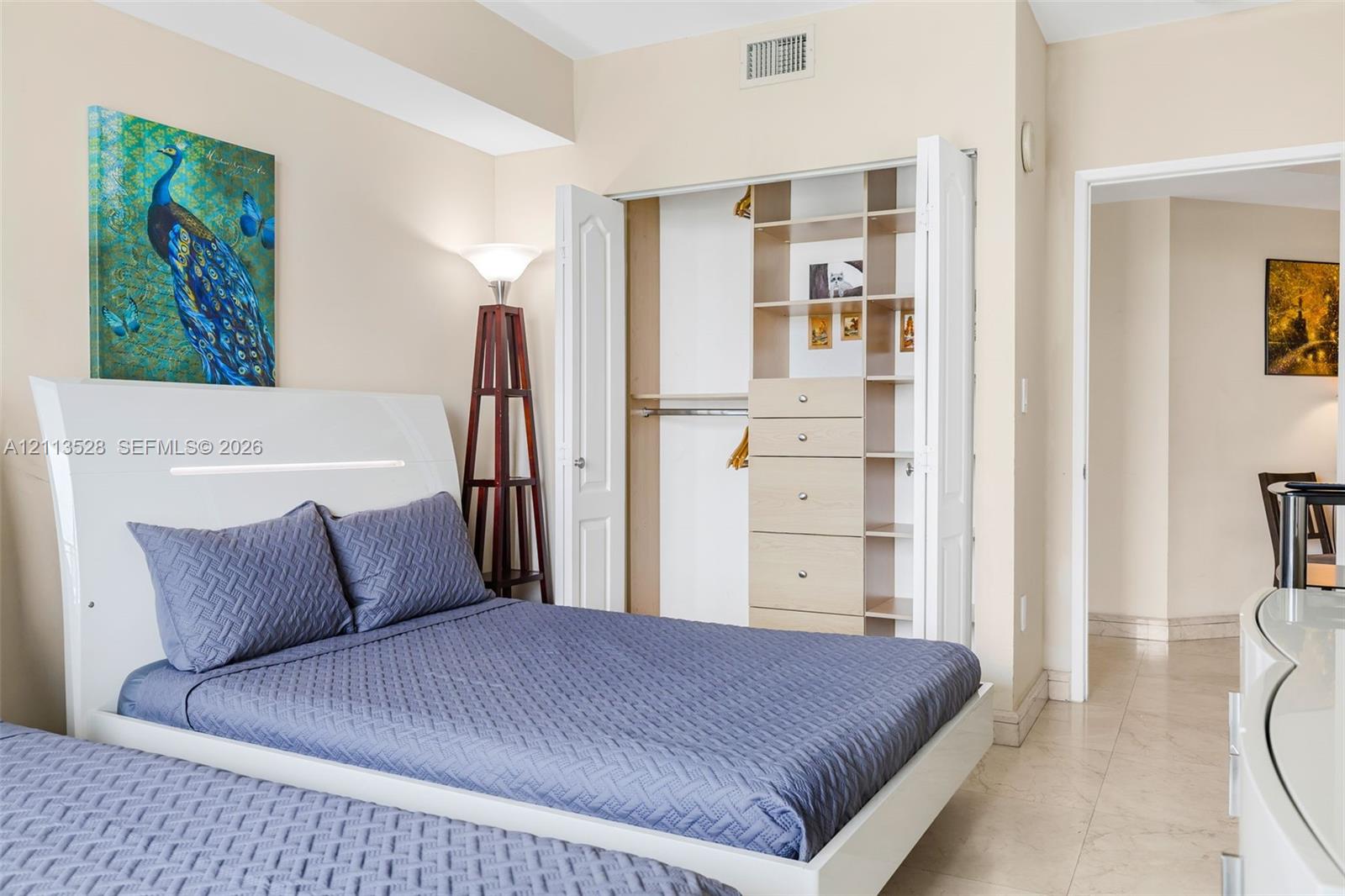 Closet featuring built-in shelving and integrated drawer storage, neutral wall paint, and stone-finish flooring