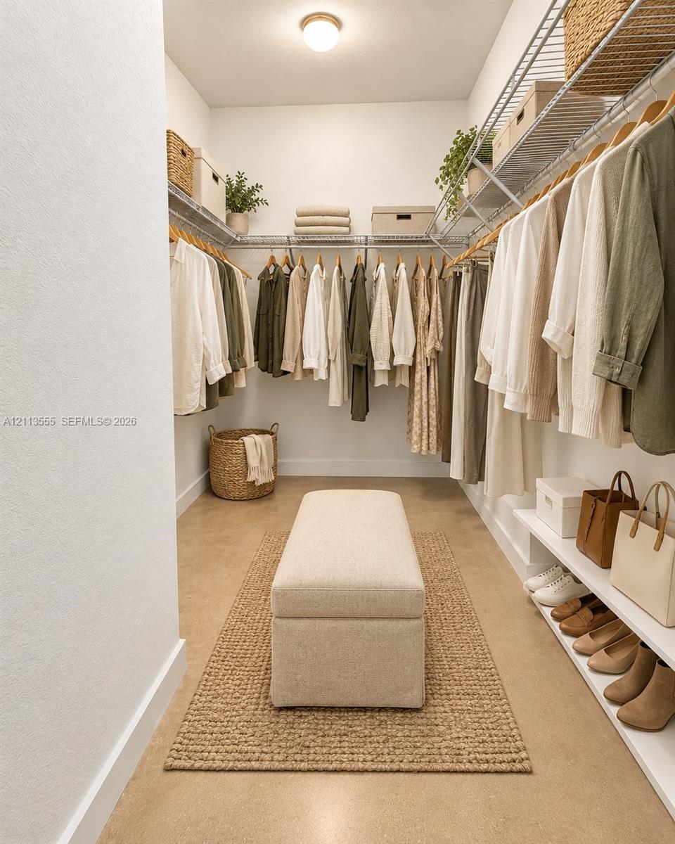Walk-in closet featuring multi-level wire shelving, integrated hanging rods, and lower-level shoe storage
